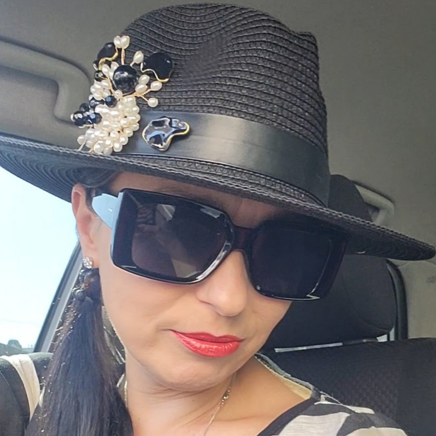 Black Straw Fedora Hat with Pearl Brooch-a picture of the hat on Tatiana close up