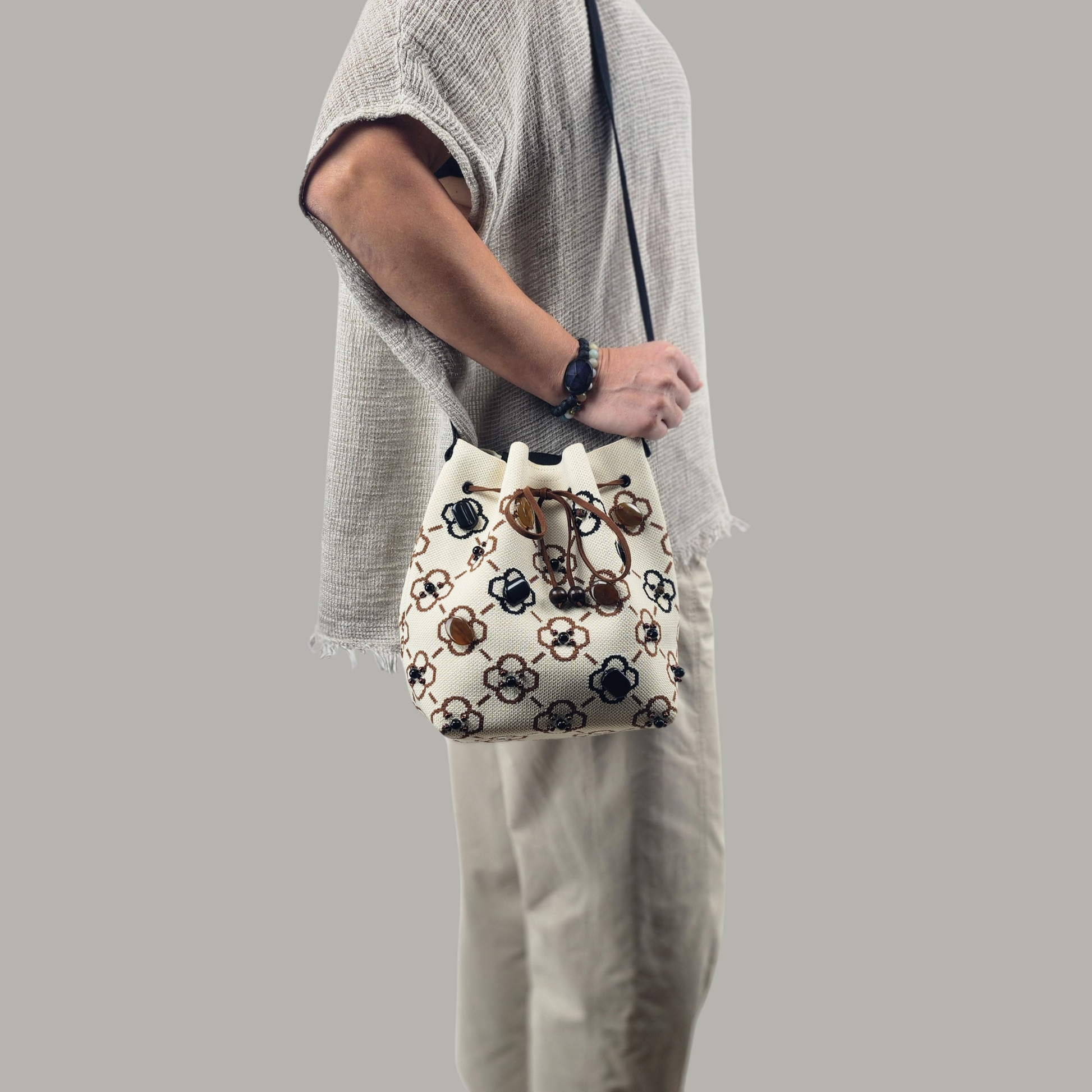 Beige-Black Fabric Bag with Green Pearls-photo of the model from the side, front side