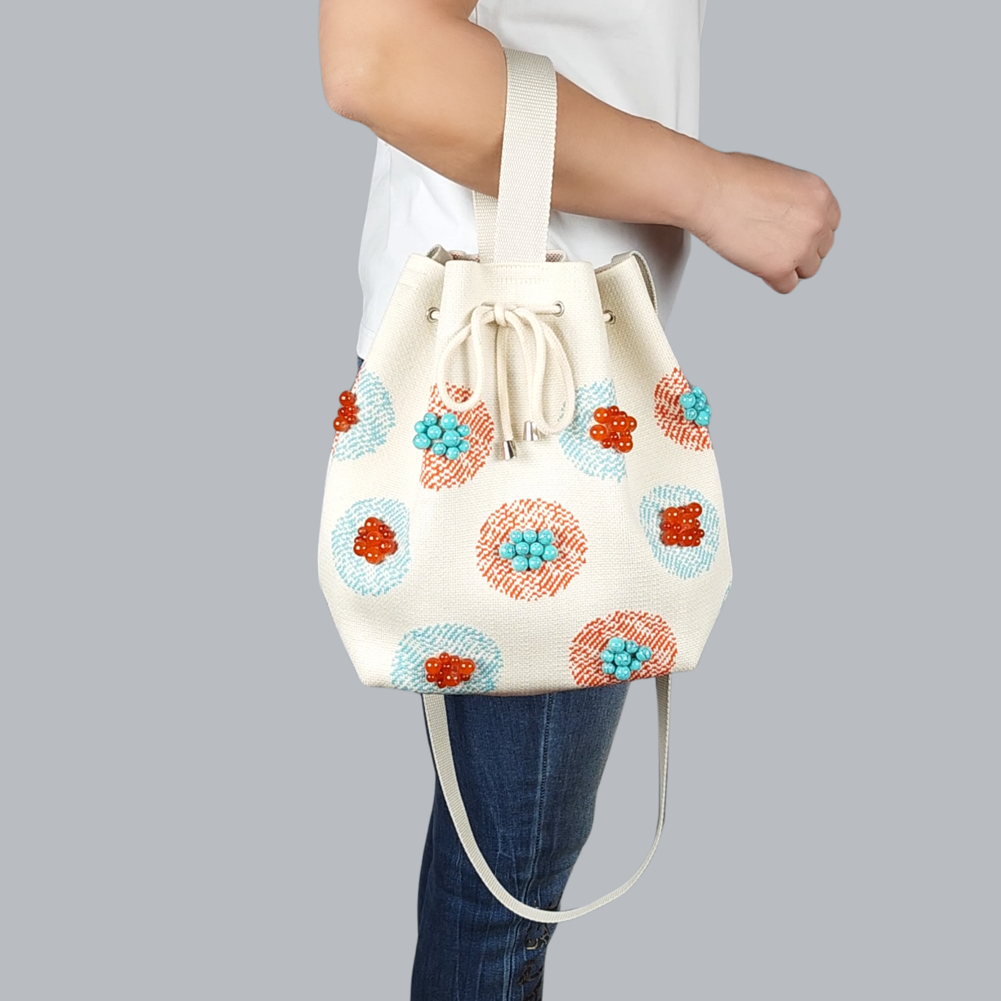 Beige Fabric Bag with Stone Accents-a close up view of the bag's arm, foreground