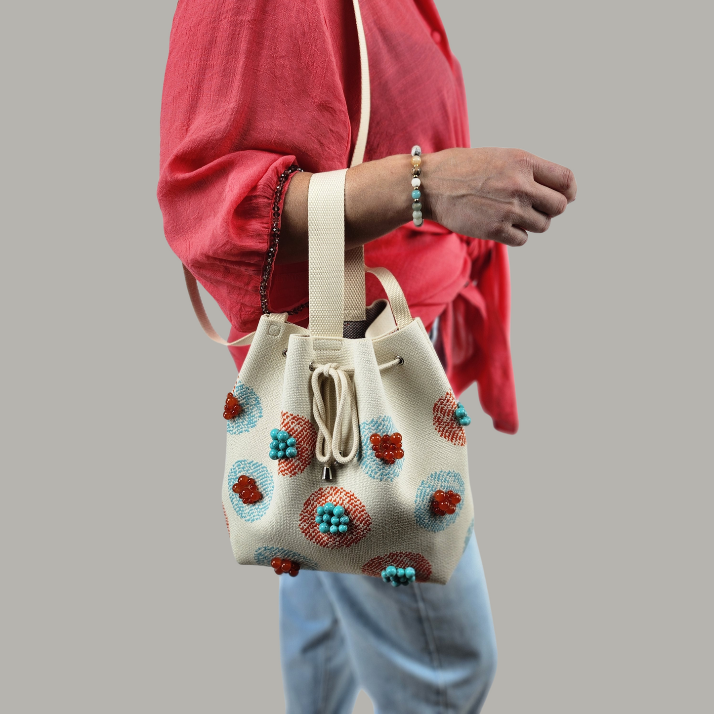 Beige Fabric Bag with Stone Accents-photo of bag on hand, short strap