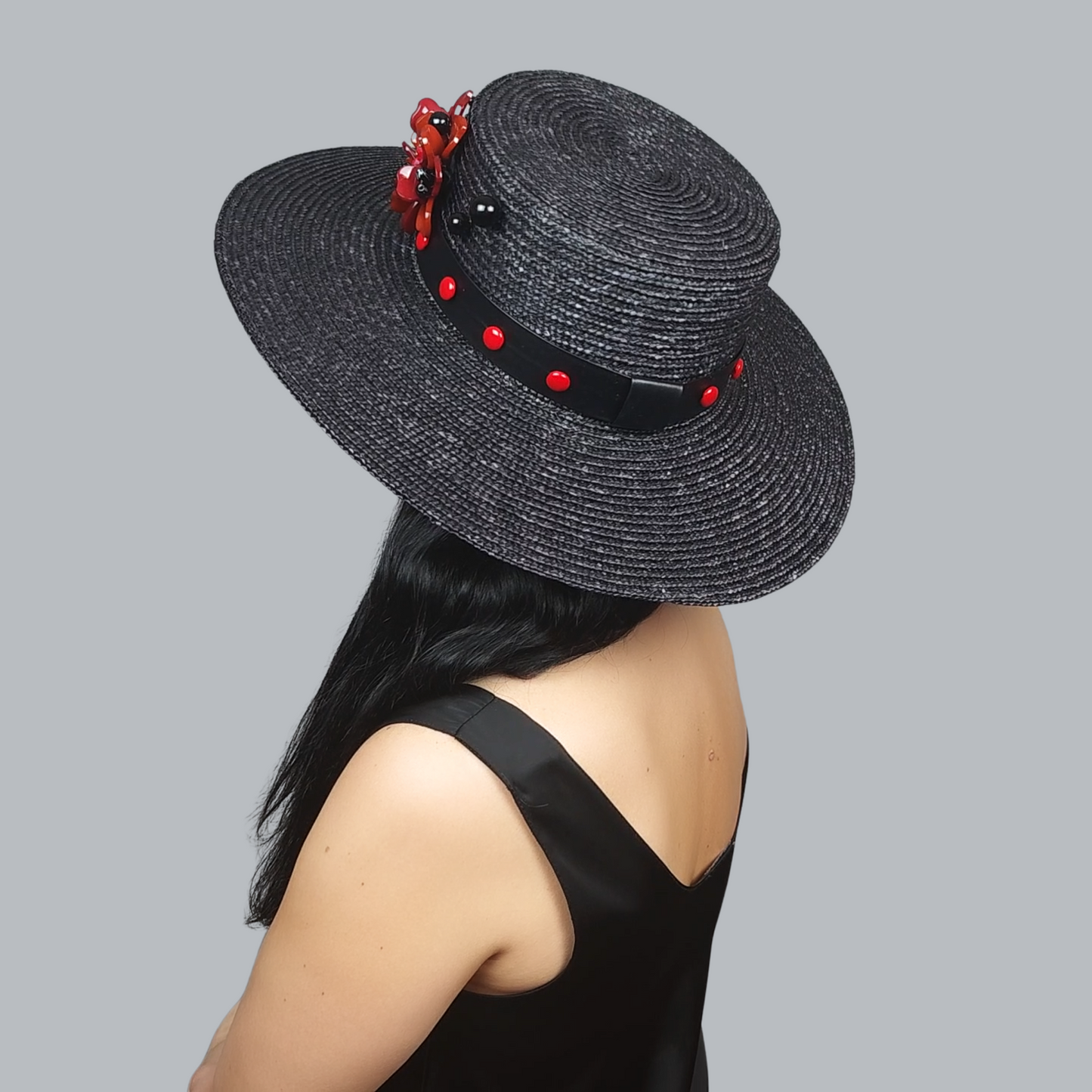 Black Straw Boater Hat with Red Flower Brooch - side view from the back