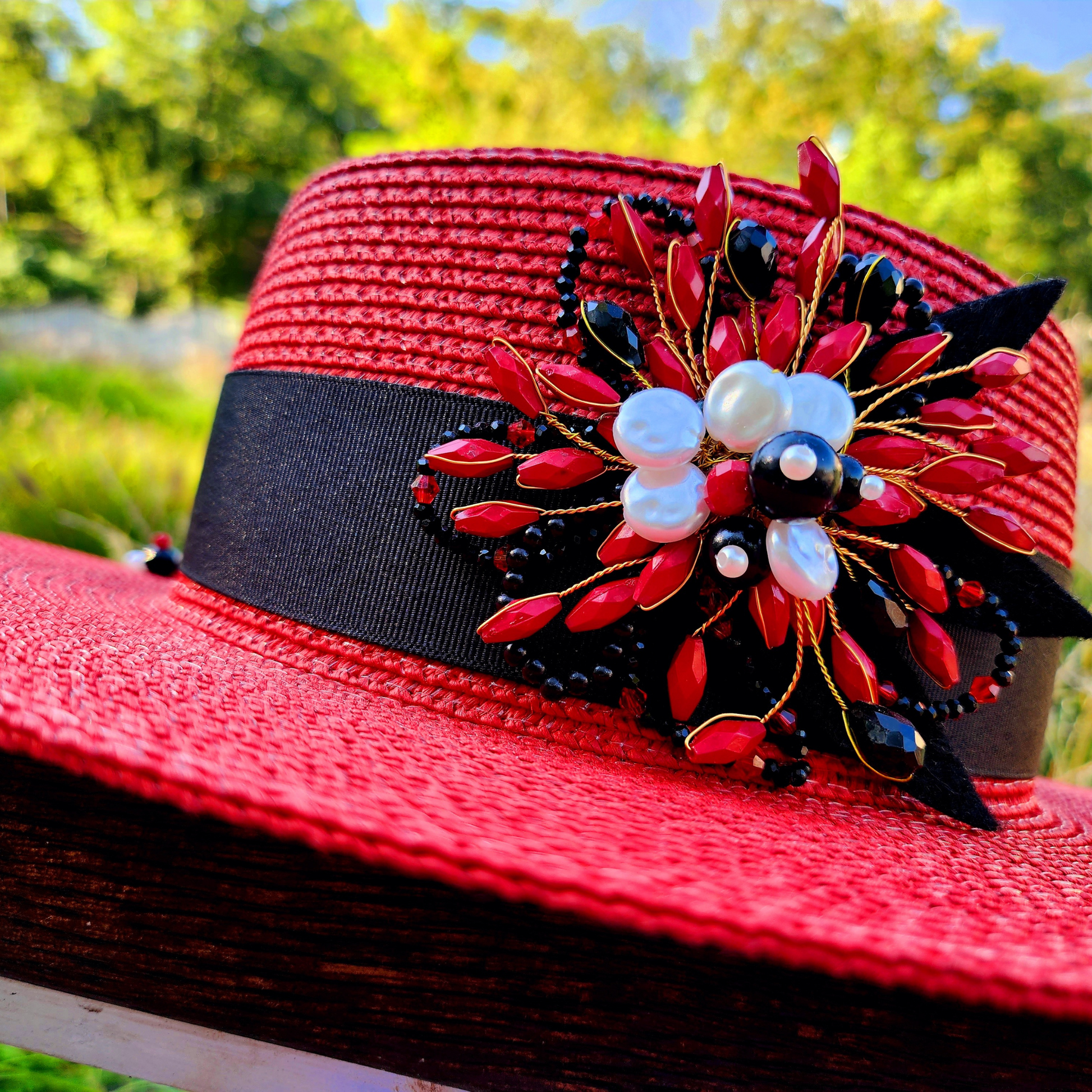 Red Straw Boater Hat with Brooch-photo of brooch on a hat, foreground close up 2